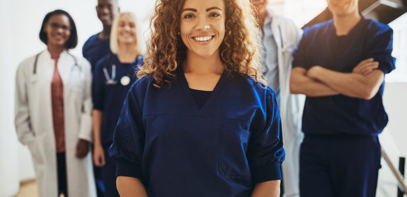 Smiling female with medical colleagues