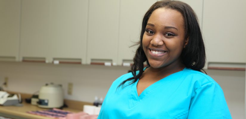 Smiling nurse in teal shirt